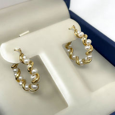 our gold wrapped pearl hoops showcases our traditional pearls with a unique twist