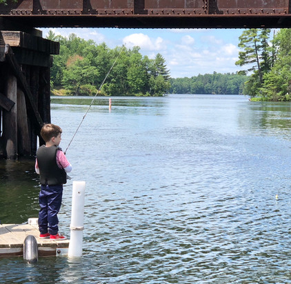 boy fishes off dock at northern wisconsin resort