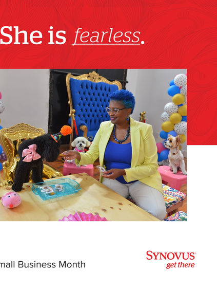 Woman seated on throne next to table with black dog on top of it.