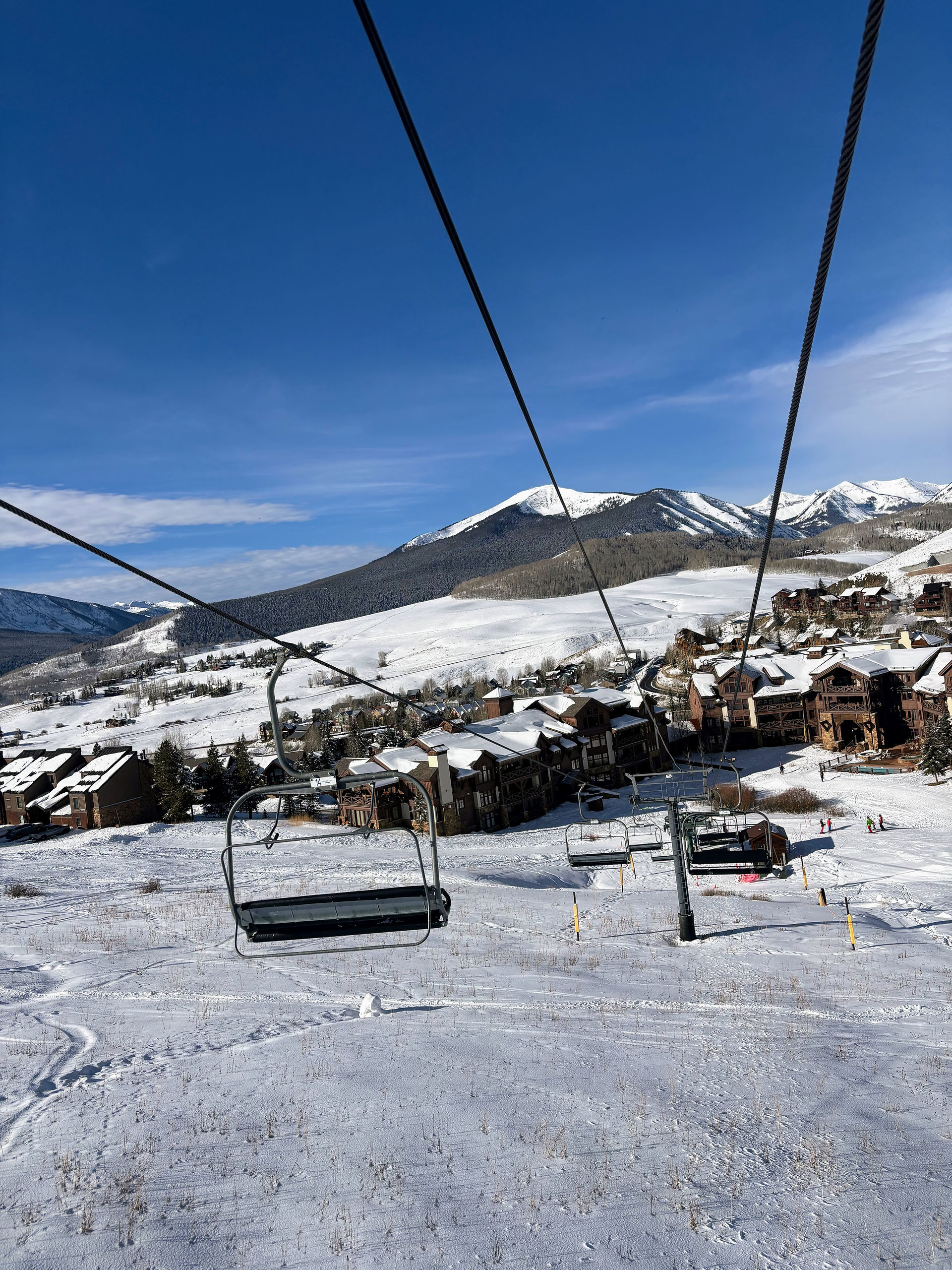 chairlift in front of snowy mountain view
