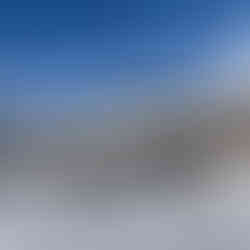 chairlift in front of snowy mountain view