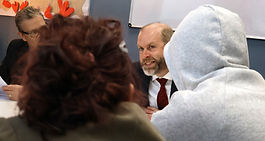 Jonathan Reynolds MP looks on smiling at students