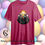 Thumbnail: Dark pink t-shirt with two lambs, glowing Easter eggs. Celebrate In Style.