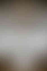 Howe farms venue, white cloth and chandeliers, wooden chairs with large windows