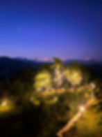 Emaho Boutique Resort at dusk with a stunning Kanchenjunga backdrop and illuminated garden, perfect for an off-beat stay and nature lovers in Sikkim.