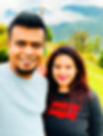 Couple posing with lush green mountain backdrop at Emaho Boutique Resort, highlighting the resort's appeal for romantic getaways in Sikkim.