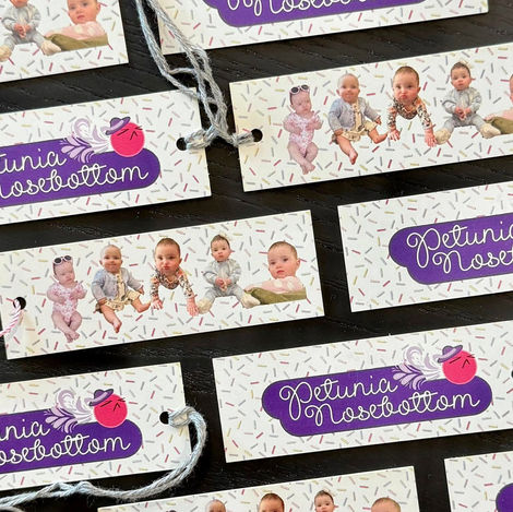 From the time my daughter was really young, I gave her an alter ego for her fussiest moments: "Petunia Nosebottom." Petunia is the ultimate embodiment of sass, grumpiness, spunk, spice, and feistiness—all the attitude, none of the responsibility. So naturally, when it came time for my daughter's first birthday, Petunia needed her moment to shine. I created a custom tag dedicated to her, complete with photos of Petunia in action displayed on the back of each tag. It was the perfect playful touch to celebrate her one-of-a-kind personality!