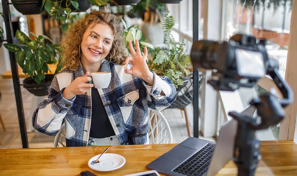 portrait-of-smiling-woman-blogger-in-casual-wear-posing-to-the-camera-with-cup-of-coffee -