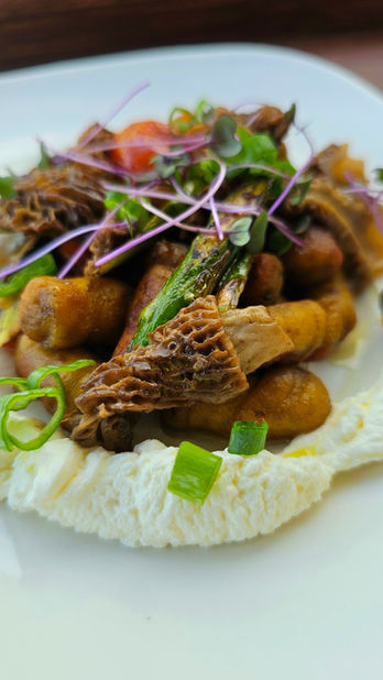 Pillowy spiced potato gnocchi nestled on cultured cream, crowned with fresh wild=picked morels, in house-made a2 butter, garlic kissed lemon zested asparagus and blistered cherry tomatoes.