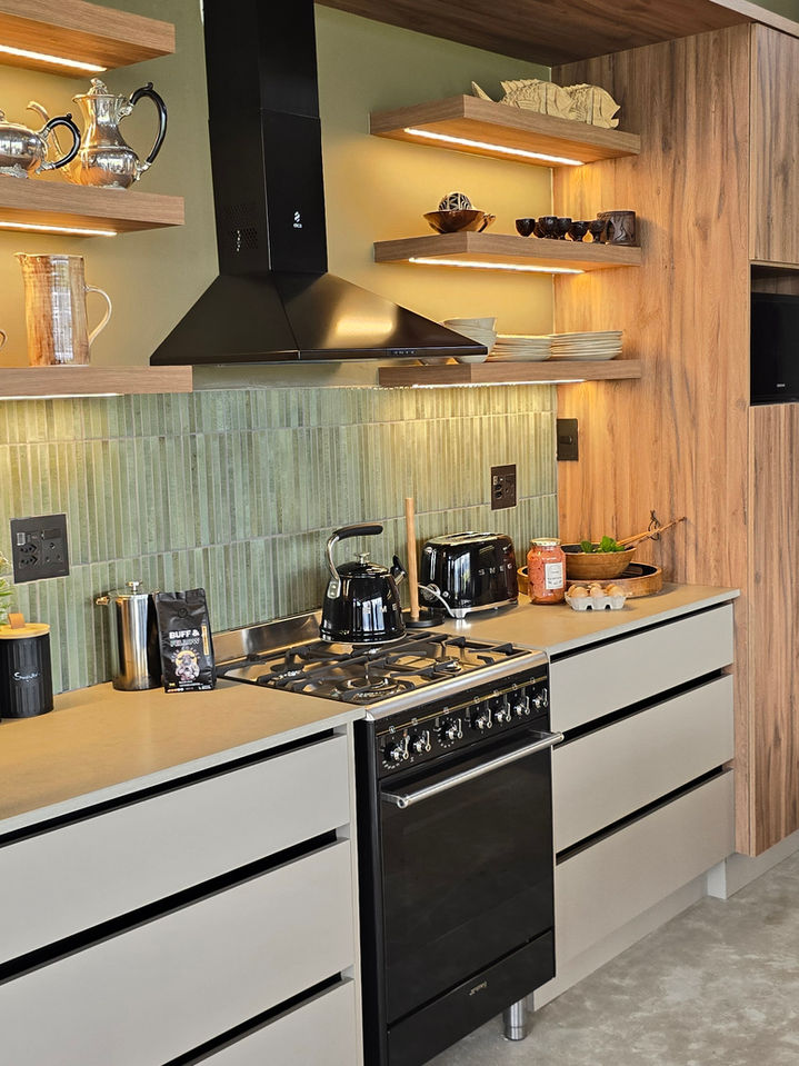Modern kitchen with black stove, illuminated wooden shelves
