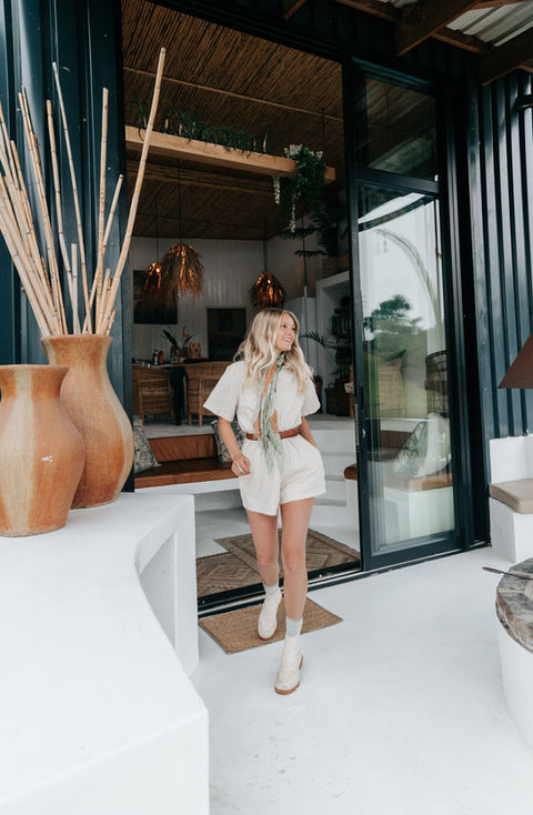 Blonde woman at entrance of modern Eco Cabana