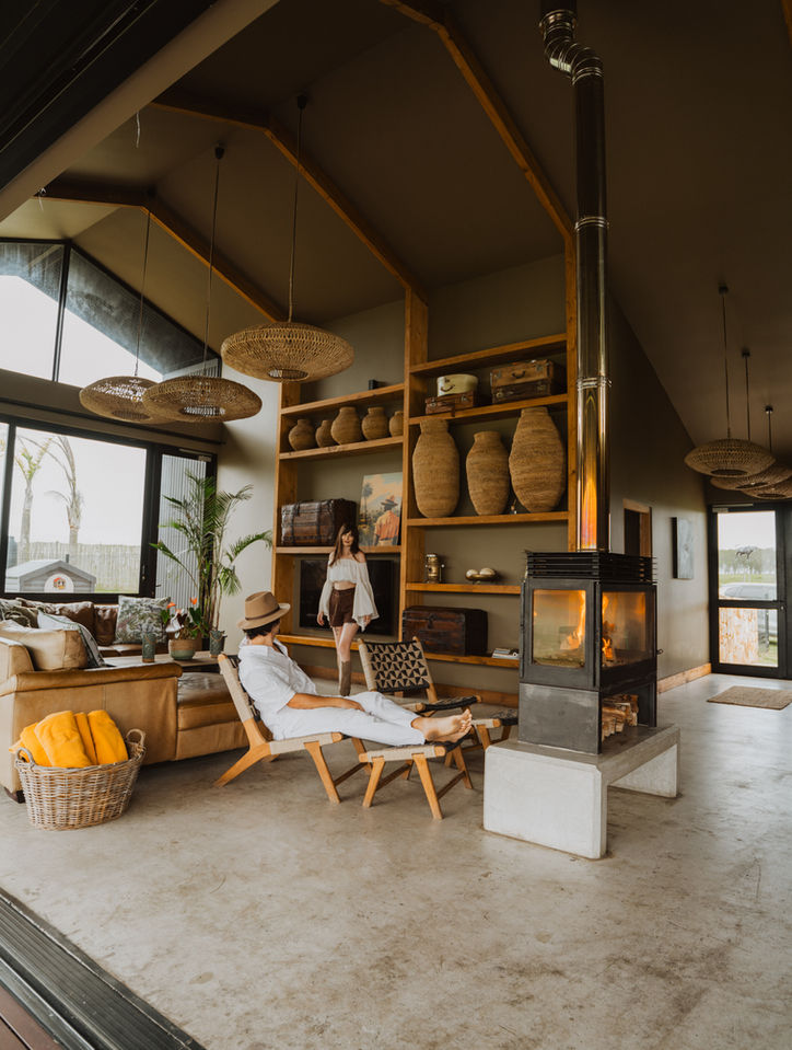 Couple relaxing in a modern lodge living room near a fireplace