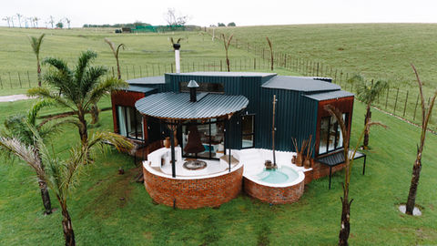 Modern eco-cabana with outdoor seating and hot tub at Buff and Fellow