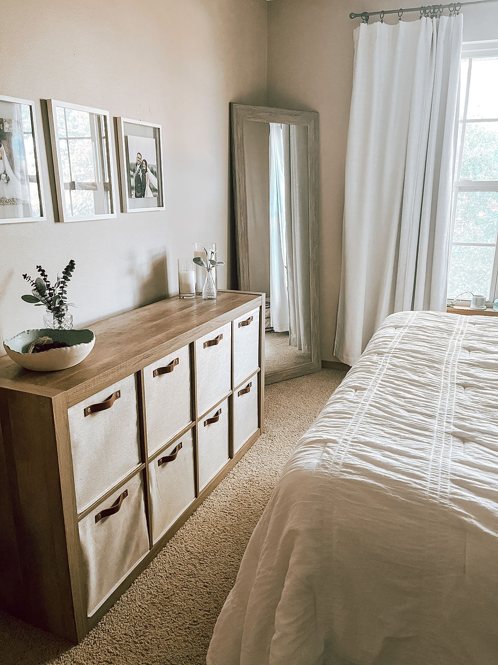 a bedroom with a mirror and cube shelf