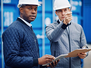 engineers-disucssing-shipping-logistics-while-stan-2023-11-27-05-26-37-utc.jpg