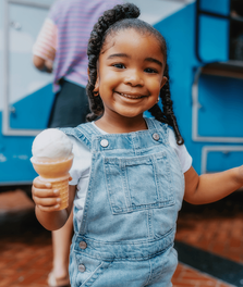 A child enjoys ice cream at an Art & A/C event