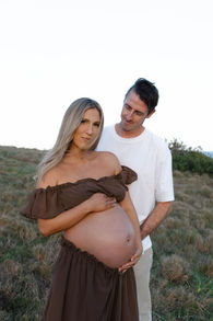 a man and lady holding her pregnant belly