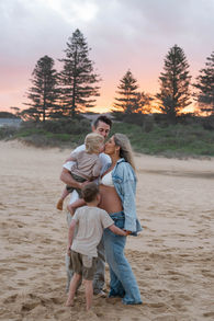 a family cuddling on the sand