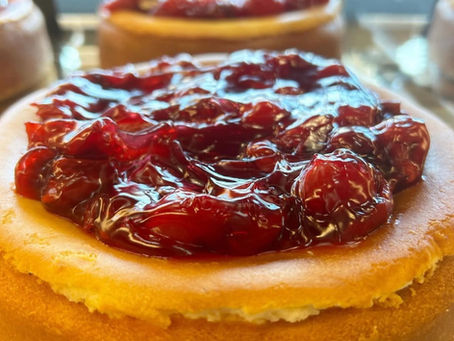 Close up of our Original NY Style Cheesecake topped with Cherry Pie Filling