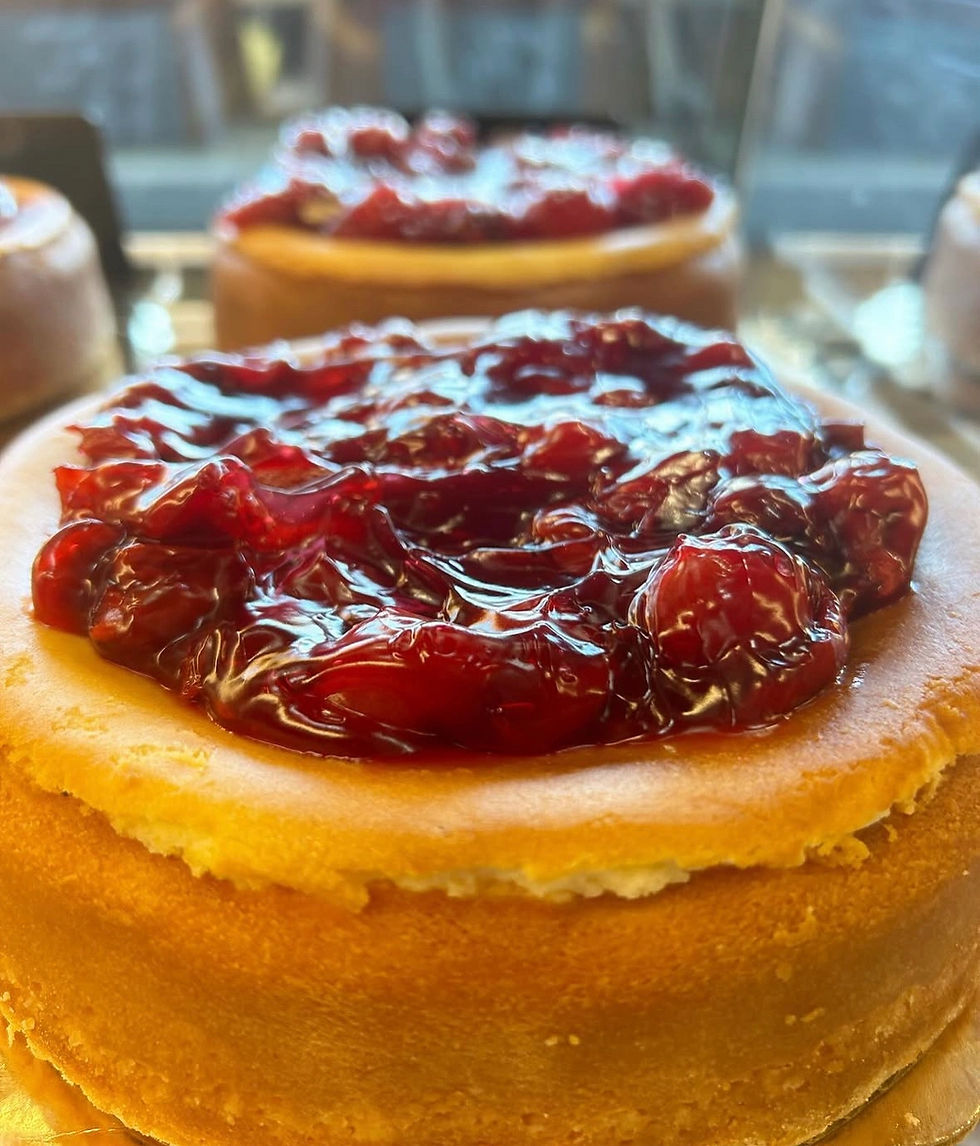 Close up of our Original NY Style Cheesecake topped with Cherry Pie Filling
