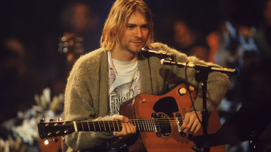 Kurt Cobain performing on acoustic guitar