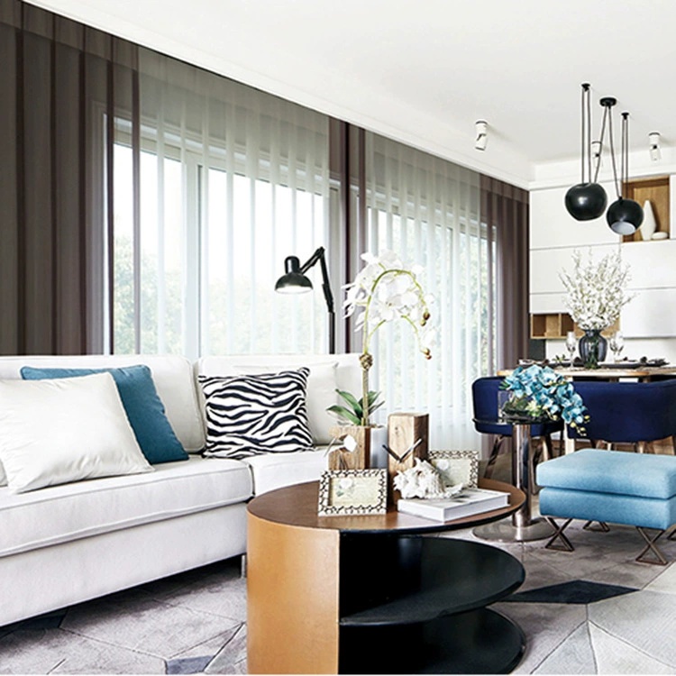 Modern living room with white sofa, zebra pillow, curved table, and blue chairs. Large window with sheer curtains. Elegant and bright.