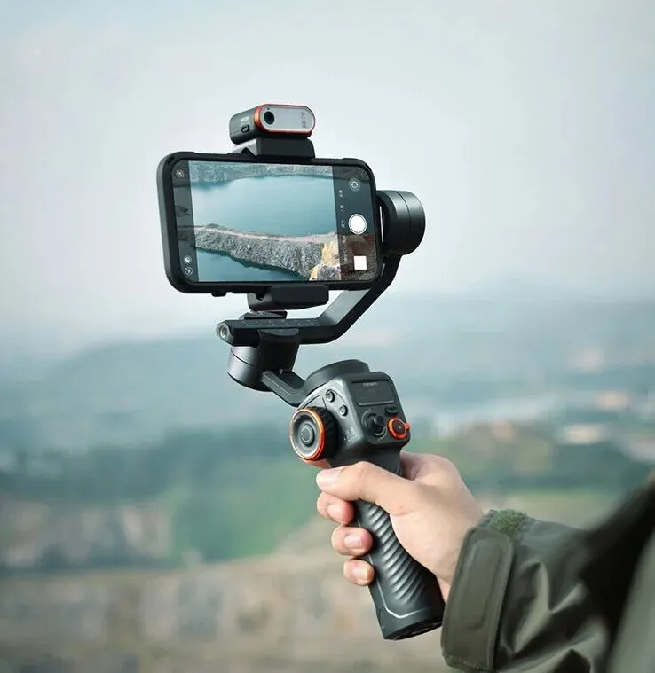 hand-held phone gimbal pointing at a lake
