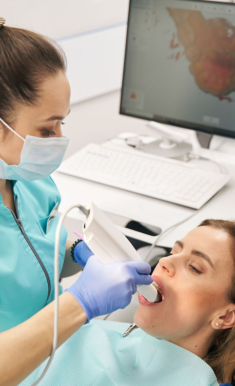 A dentist using an intraoral scanner to take digital impressions from a patient, ready for seamless submission to Aceso Dental Lab.