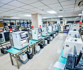 The clean and modern production floor at Aceso Dental Lab, featuring a line of cutting-edge 3D printers and milling machines for high-volume, precise manufacturing.