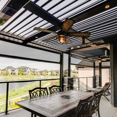 Luxury patio featuring a StruXure motorized pergola with a wood-grain finish and integrated lighting, designed by Bluebird Design & Landscape.