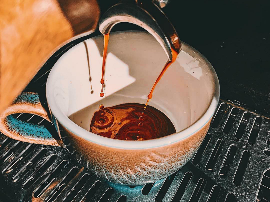 Coffee extraction being poured into a coffee cup