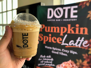 DOTE"s Pumpkin Spice Latte with a poster promoting the seasonal drink
