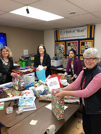 Four volunteers pack Christmas gifts at Volunteer Nanaimo.