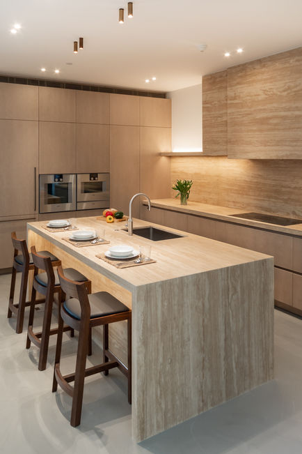 Kitchen island styled with plates and cutlery, photographed to highlight materials and proportions.