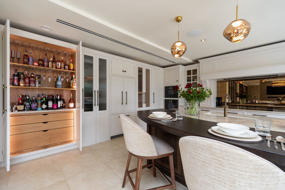 Kitchen bar and display shelving feature with integrated lighting beside the island