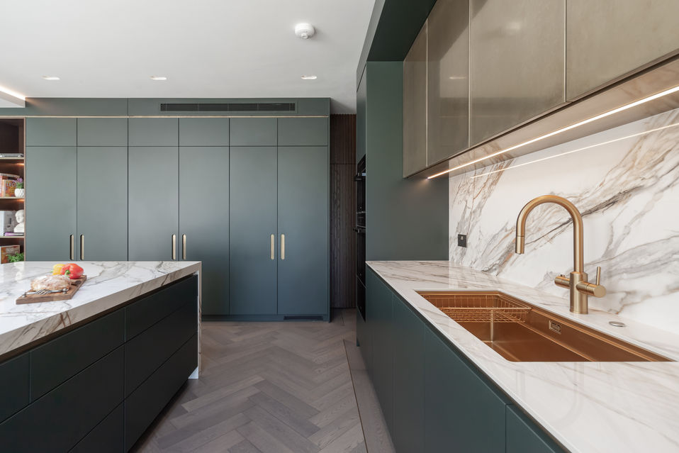 Brass tap and undermount sink detail in modern kitchen