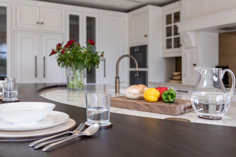 Styled kitchen island with table setting, flowers and fresh produce