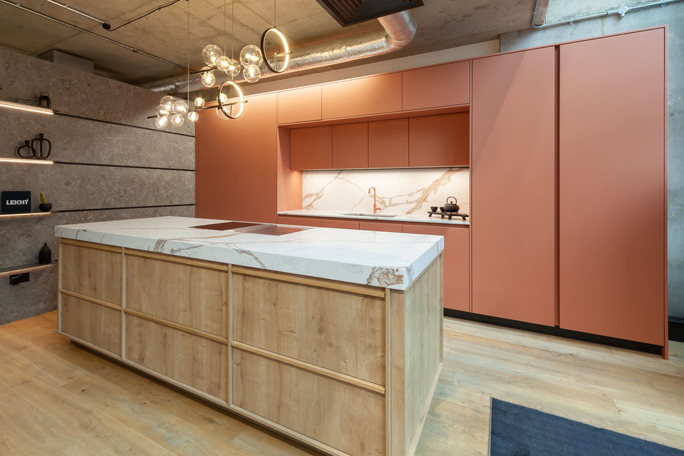 Side angle showing the timber island and Hot Fuzz cabinetry wall with integrated niche lighting.