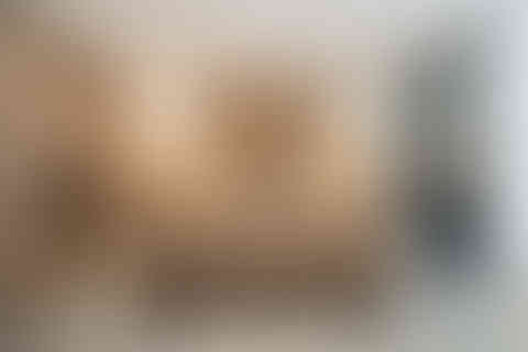 Wide view of a contemporary wood-toned kitchen with island seating and warm under-cabinet lighting, photographed in Maida Vale, London.