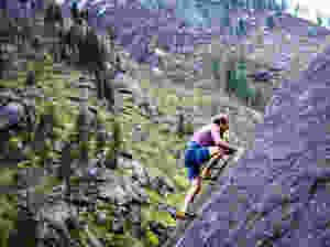 man climbing mountain