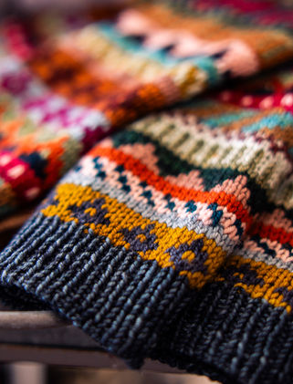 Closeup of a hand knit colorwork sweater showing the floats