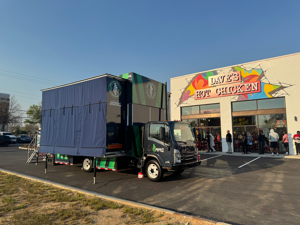 Mobile Mulligans Golf simulator set up for a grand opening event with Dave's Hot Chicken