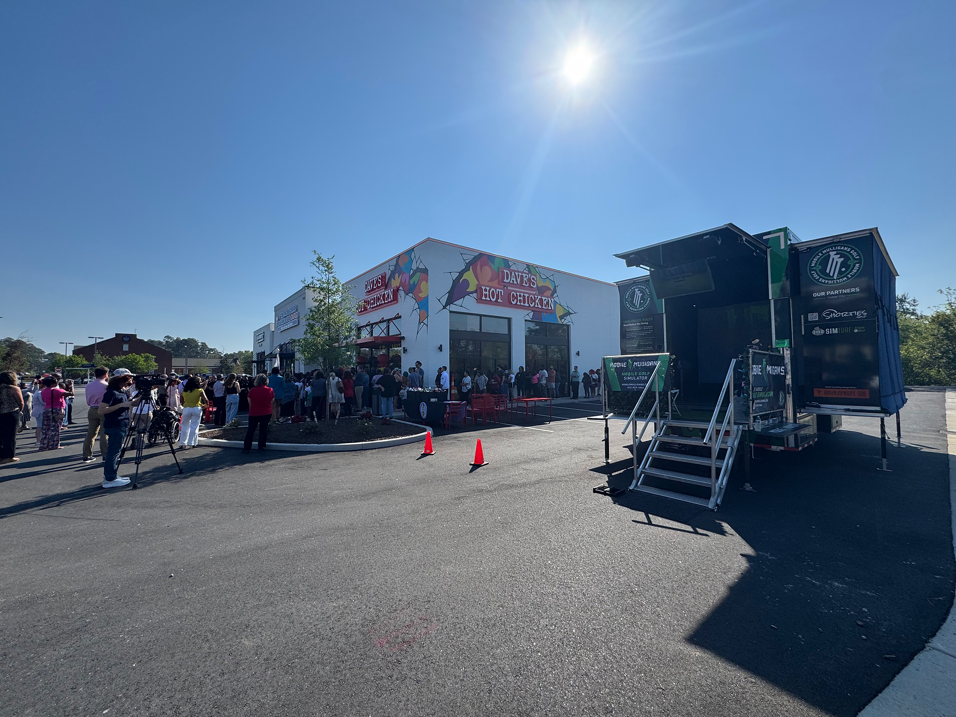 Mobile golf simulator truck set up outside Dave’s Hot Chicken Augusta grand opening event
