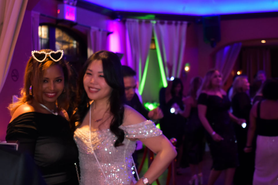 Two women posing on the dance floor during a private party at a Queens event venue