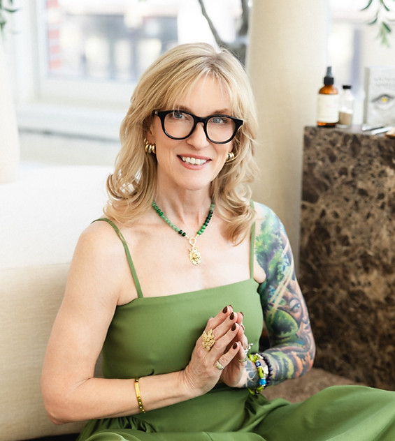Woman in green dress sitting in a prayer pose