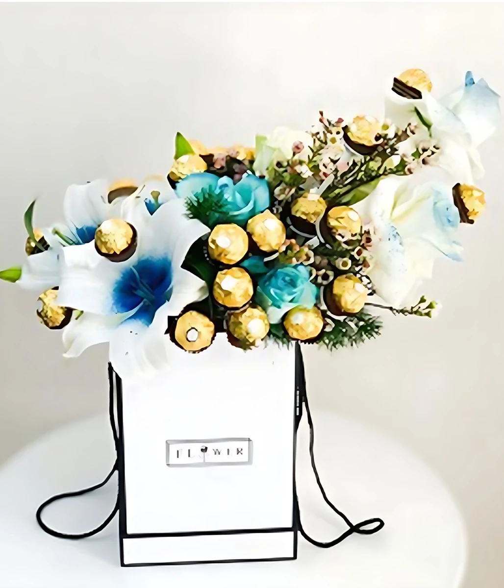 Gifting with Solace (Ferrero) Flowers, a luxurious arrangement of roses, lilies and Ferrero Rocher chocolates.