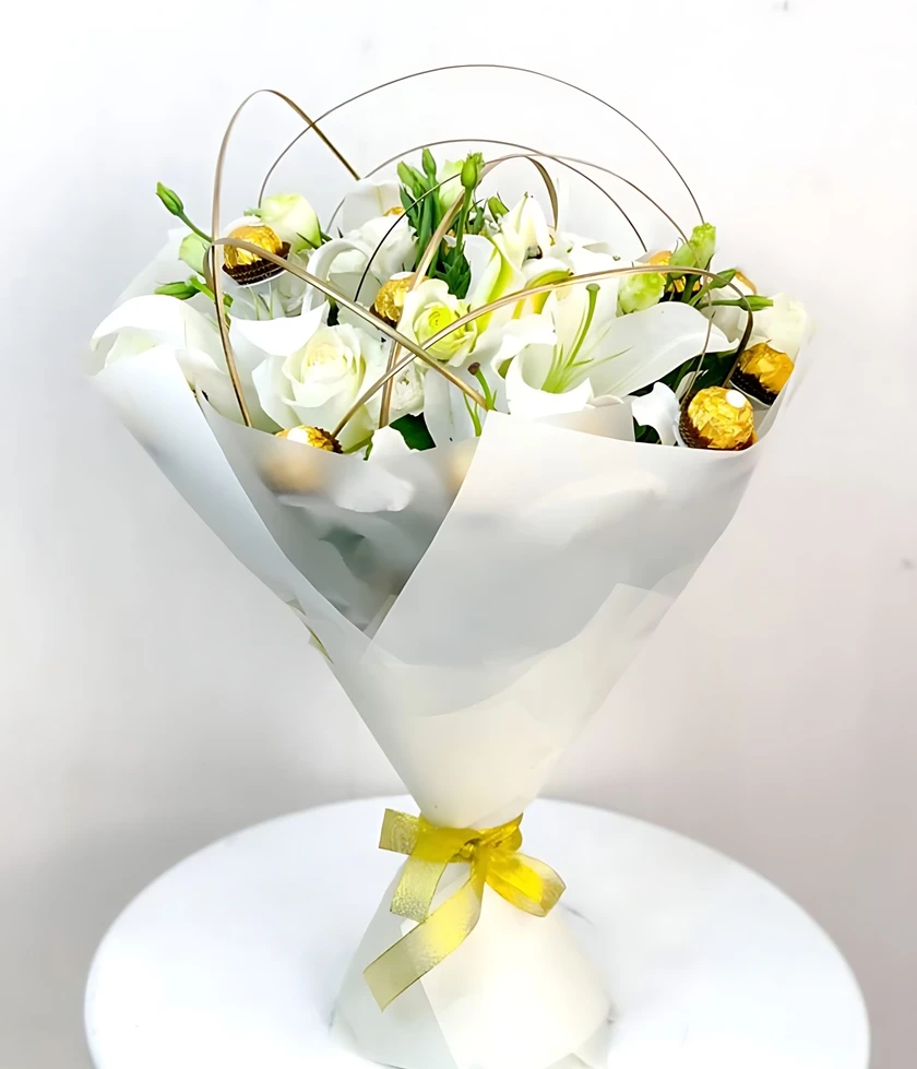 Gift-giving with our Angels Breath (Ferrero) Flower Bouquet, featuring roses, lilies, and Ferrero Rocher chocolates.