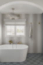 Soaking tub with penny tile surround and chandelier
