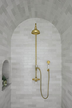 Shower with exposed brass fixtures