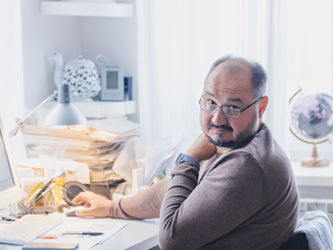 Man at computer giving a questioning look